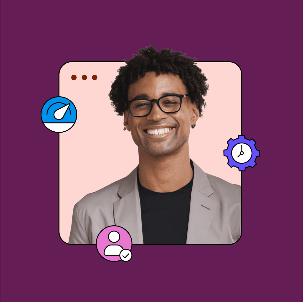 Smiling man with curly hair and glasses in a suit.